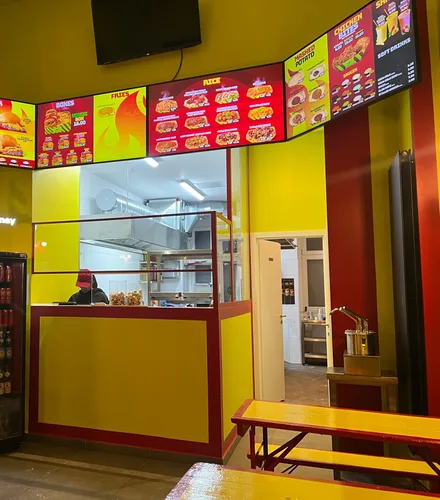 Inside the shop: the menu above the counter, the open kitchen behind it
